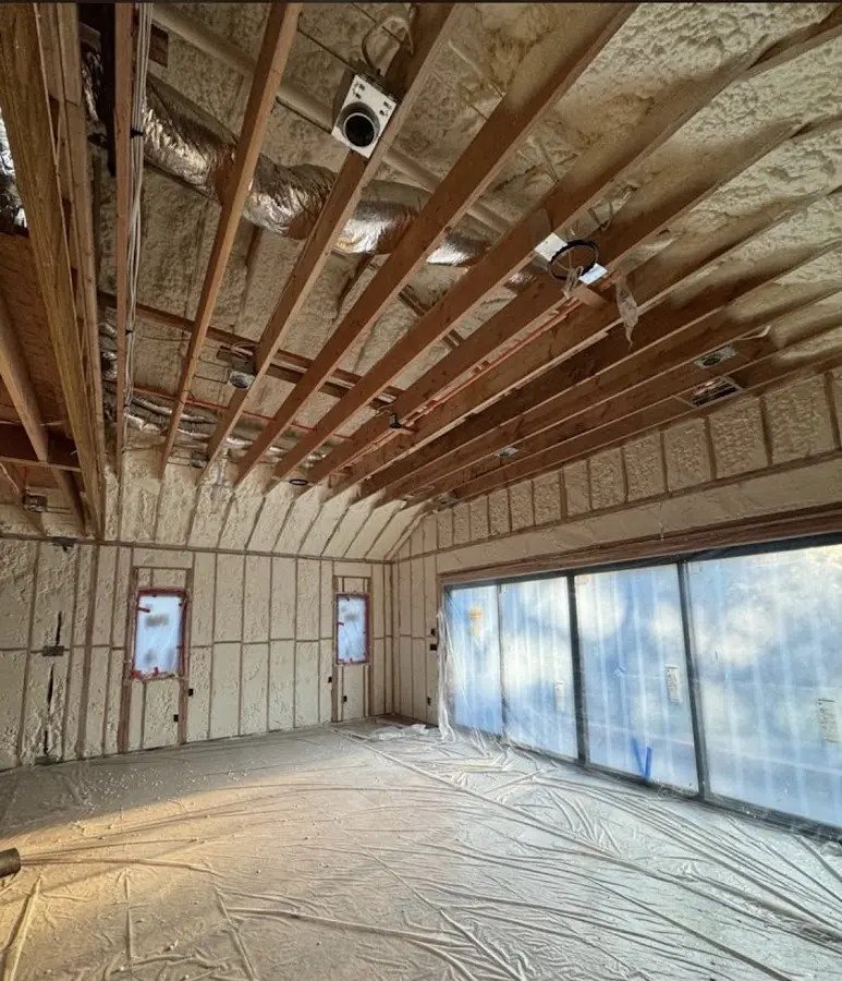 Interior walls and ceiling insulated with spray foam during new construction in Eden Isle